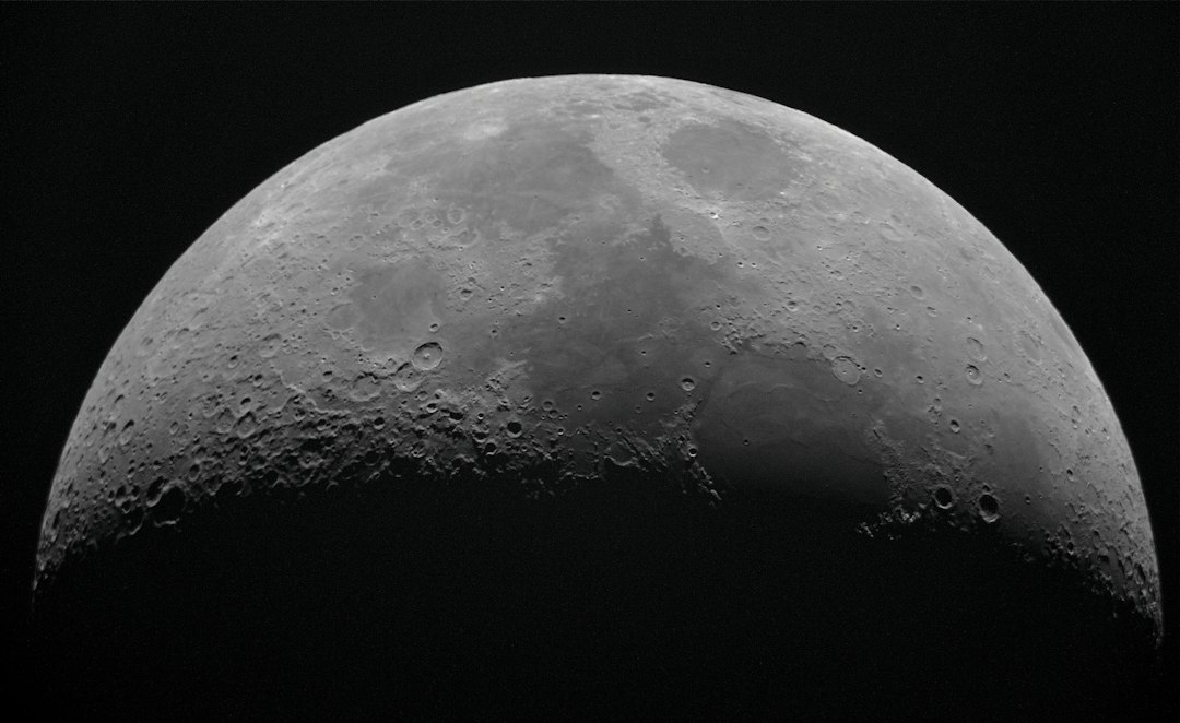 Lua crescente com detalhes de crateras em fotografia com telescopio