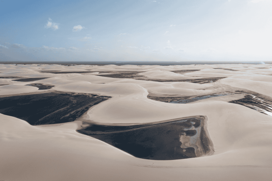 Paisagem panorâmica de dunas e lagoas secas nos Lençóis Maranhenses